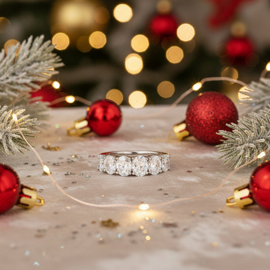 A 14k white gold oval diamond band with multiple oval-shaped diamonds set throughout.